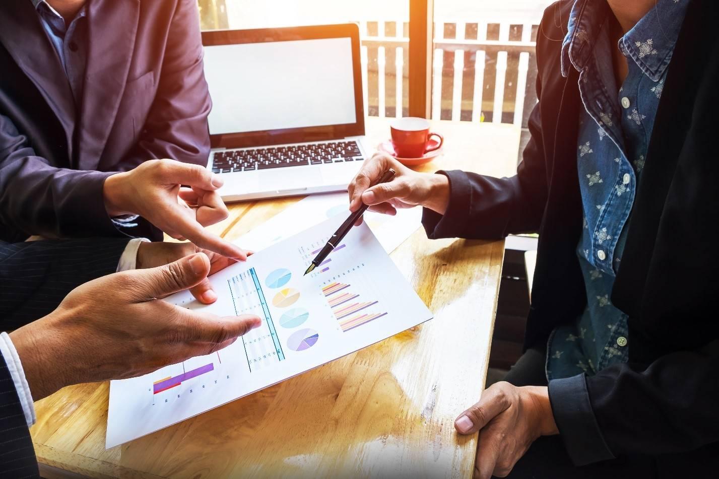 Finance professionals reviewing complex securities valuation report