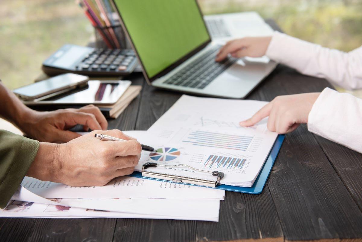 Valuation team analyzing PPA report charts and financial data at a desk