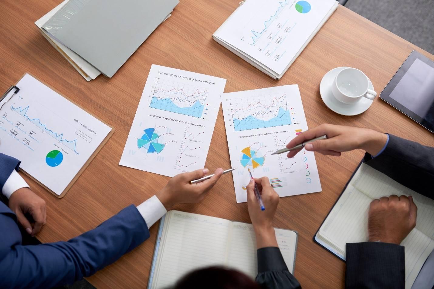 analysts discussing employee stock option valuation data and pricing charts