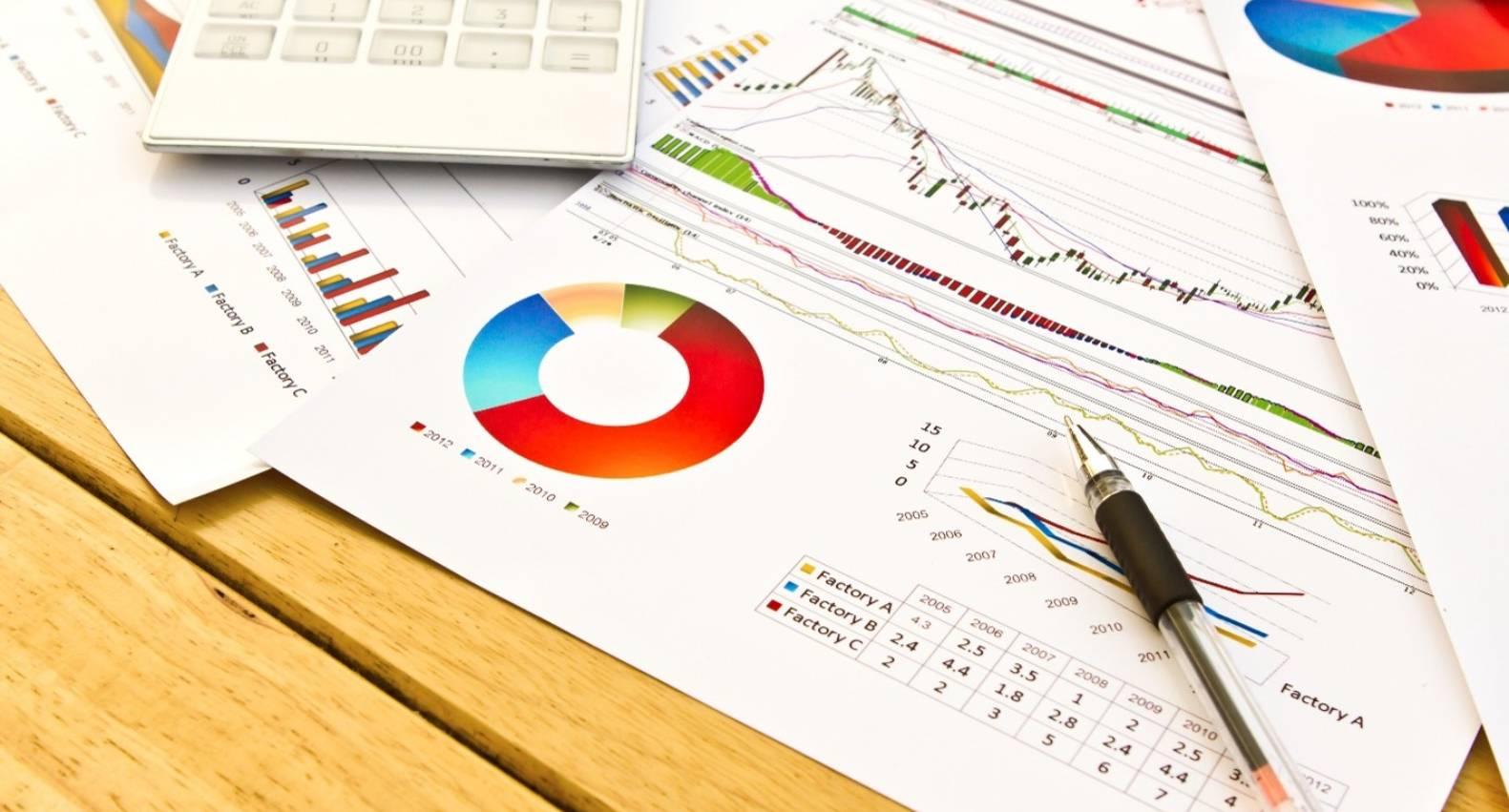 Financial charts, pie graphs, and a calculator representing purchase price allocation analysis