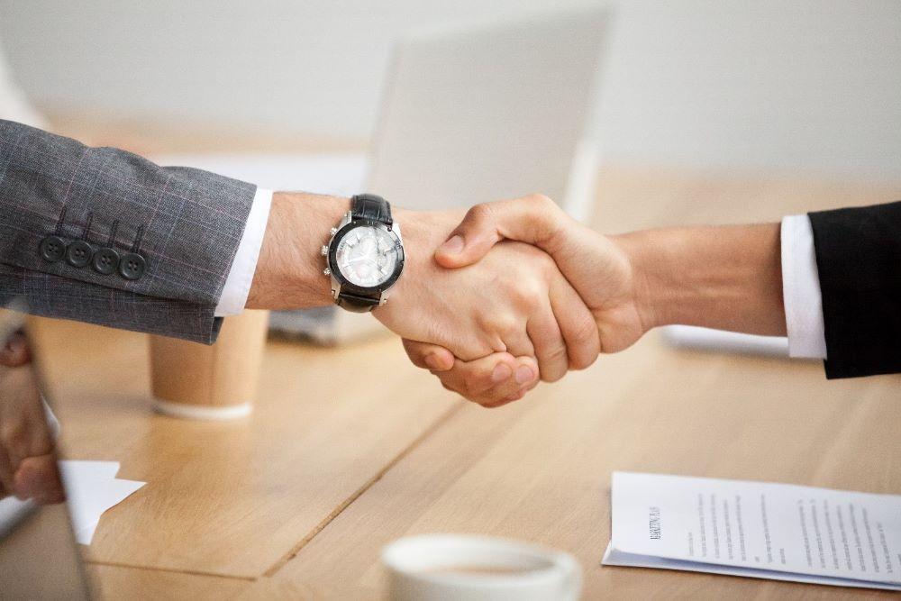 Executives finalizing an acquisition agreement related to purchase price allocation and asset valuation