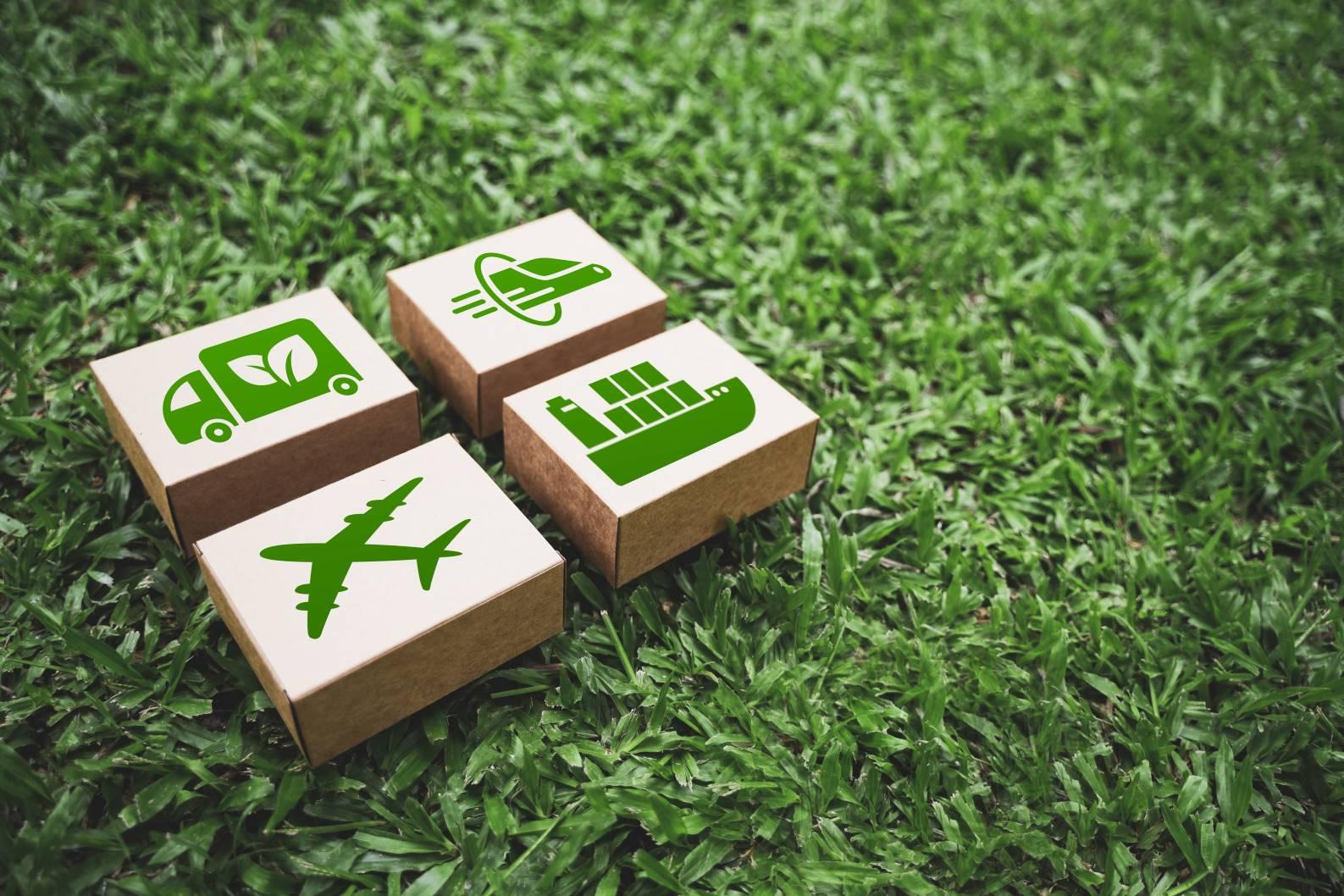Shipping boxes with green logistics icons, illustrating supplier sustainability and Scope 3 emissions
